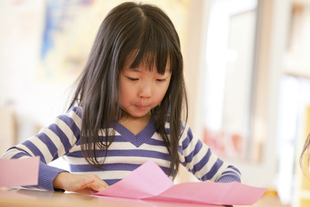 Folding origami nursery girlsの写真素材