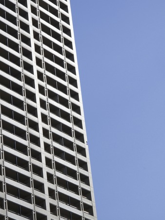 Blue skies and high rise apartment buildingsの写真素材