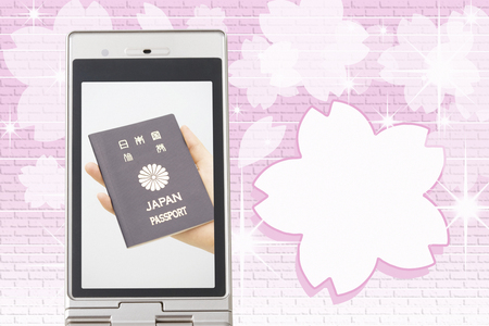 Women with a passport that moves to the mobile screenの写真素材