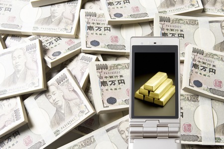 Gold and wad it moves to the mobile screenの写真素材