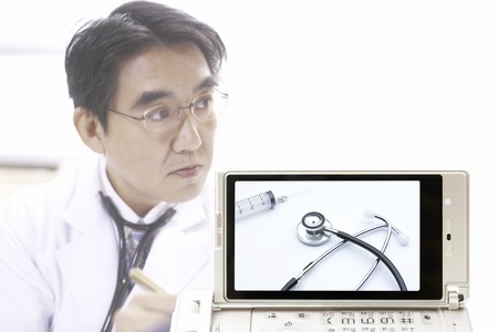 Medical devices goes to the doctor and the mobile screenの写真素材