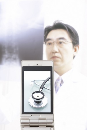 Stethoscope that goes to the doctor and the portable screen to see the X-ray photoの写真素材