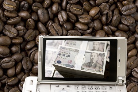 Cash and coffee beans, which moves to mobileの写真素材