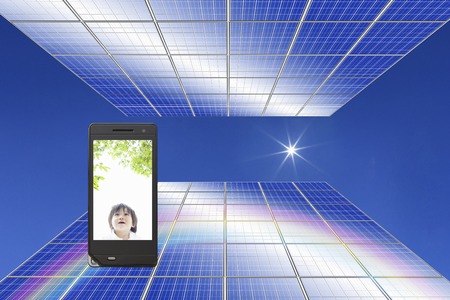 Baby moves to solar panel and a portable screenの写真素材