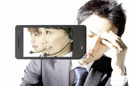 Operators and businessmen moves to mobile screenの写真素材