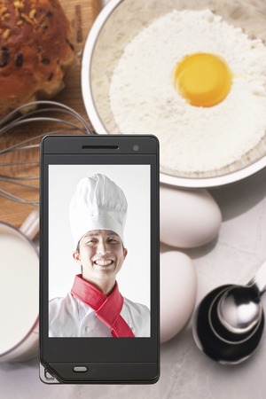 Chefs on ingredients and mobile screenの写真素材
