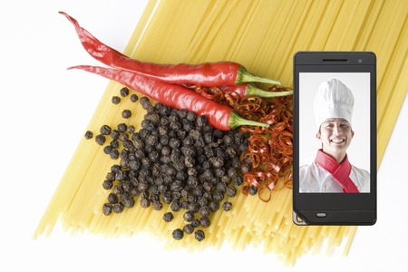 Chefs on ingredients and mobile screenの写真素材