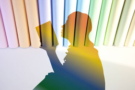 Silhouette of woman reading