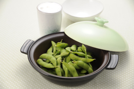 Edamame and beer in a clay potの写真素材
