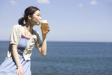 Beer drinking womanの写真素材