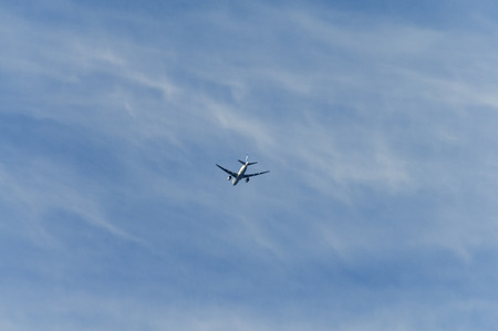 Airliner flying under the Cirrus