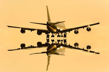Airliner to be reflected in the twilight of the surface of the waterの写真素材