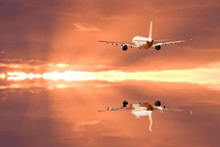 Airliner to be reflected in the twilight of the surface of the waterの写真素材