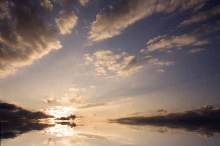 Sky and clouds of the morning glow reflected on the surface of the water