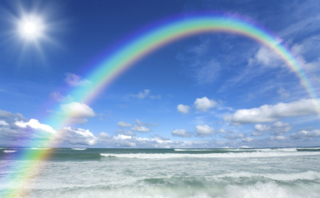 Beach waves and clouds and Sun and Rainbowの写真素材