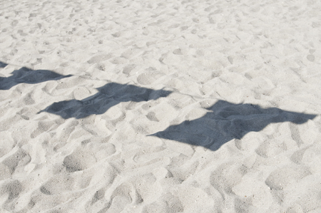 Shadow of sandy beaches and T-shirtの写真素材