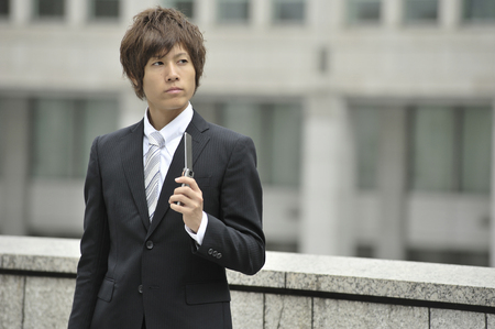 Businessman with a mobile phoneの写真素材