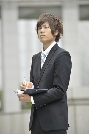 Businessman to check the schedule bookの写真素材