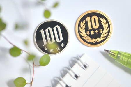 Coin and writing instrumentsの写真素材