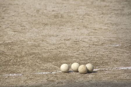 Baseball ball rolling on the groundの写真素材