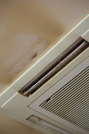 indoor air-conditioning and ceiling tobacco tar is attachedの写真素材