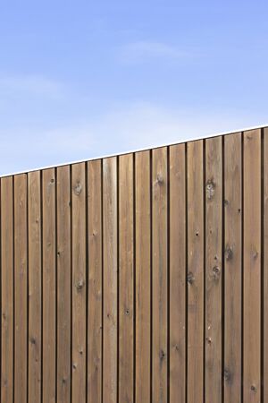 Outer wall and the blue sky of the plate of the building of the treeの写真素材