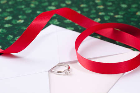 Christmas gift diamond ring and a red ribbonの写真素材