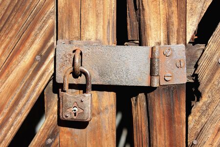 Key rusty wooden door of old warehouseの写真素材