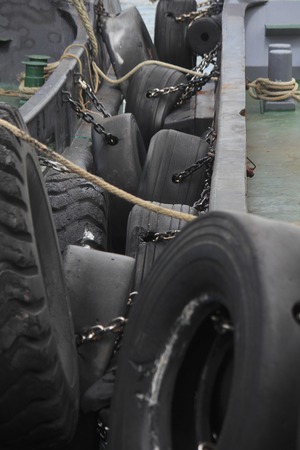 Old tires for shock absorption of fishing boatの写真素材