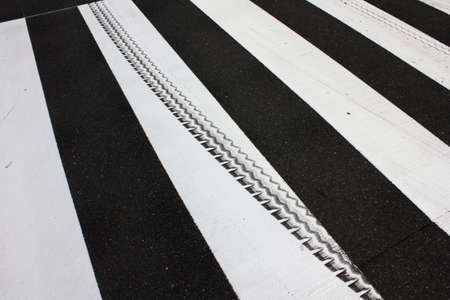 Tire marks of the white line of the crosswalk