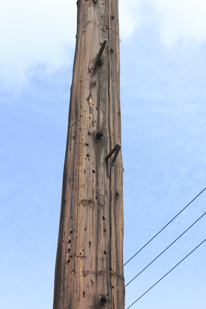 Old wooden telephone poleの写真素材