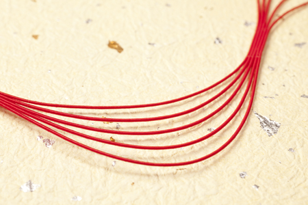 Japanese paper and a red Mizuhiki that contains the gold leaf