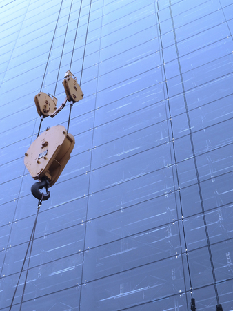 Window glass and the crane hook of high-rise building under construction