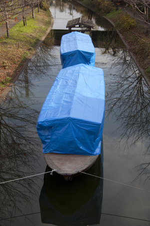 Thirty stone ship covered with blue sheetの写真素材