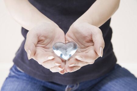 Heart of glass accessories, which put on the handの写真素材