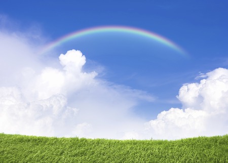Blue sky and grassland and the rainbowの写真素材