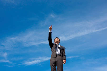 Blue sky and businessmanの写真素材