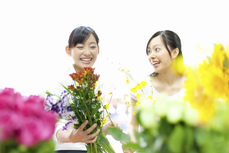 Female flower shop clerk and customerの写真素材