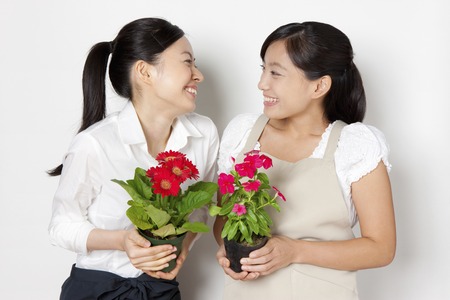 2 women with flowersの写真素材
