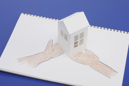 Paper Craft House and illustrations of handの写真素材