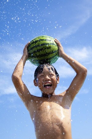 Summer of children to lift the watermelonの写真素材