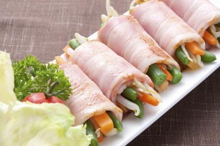 Vegetables wrapped with Baconの写真素材