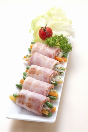 Vegetables wrapped with Baconの写真素材