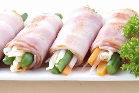 Vegetables wrapped with Baconの写真素材