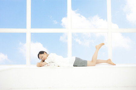 Women who plops itself down at the windowの写真素材