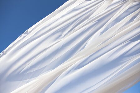 Blue sky and white curtainsの写真素材