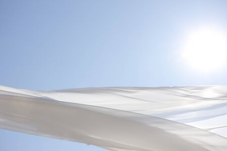 Blue sky and white curtainsの写真素材