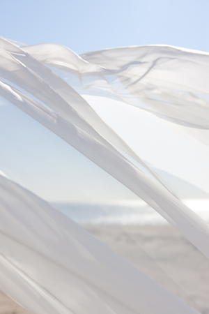Blue sky and white curtainsの写真素材