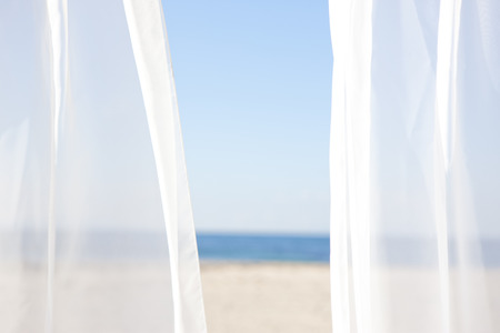 Blue sky and white curtainsの写真素材