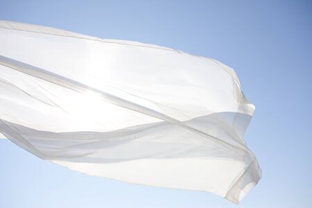 Blue sky and white curtainsの写真素材